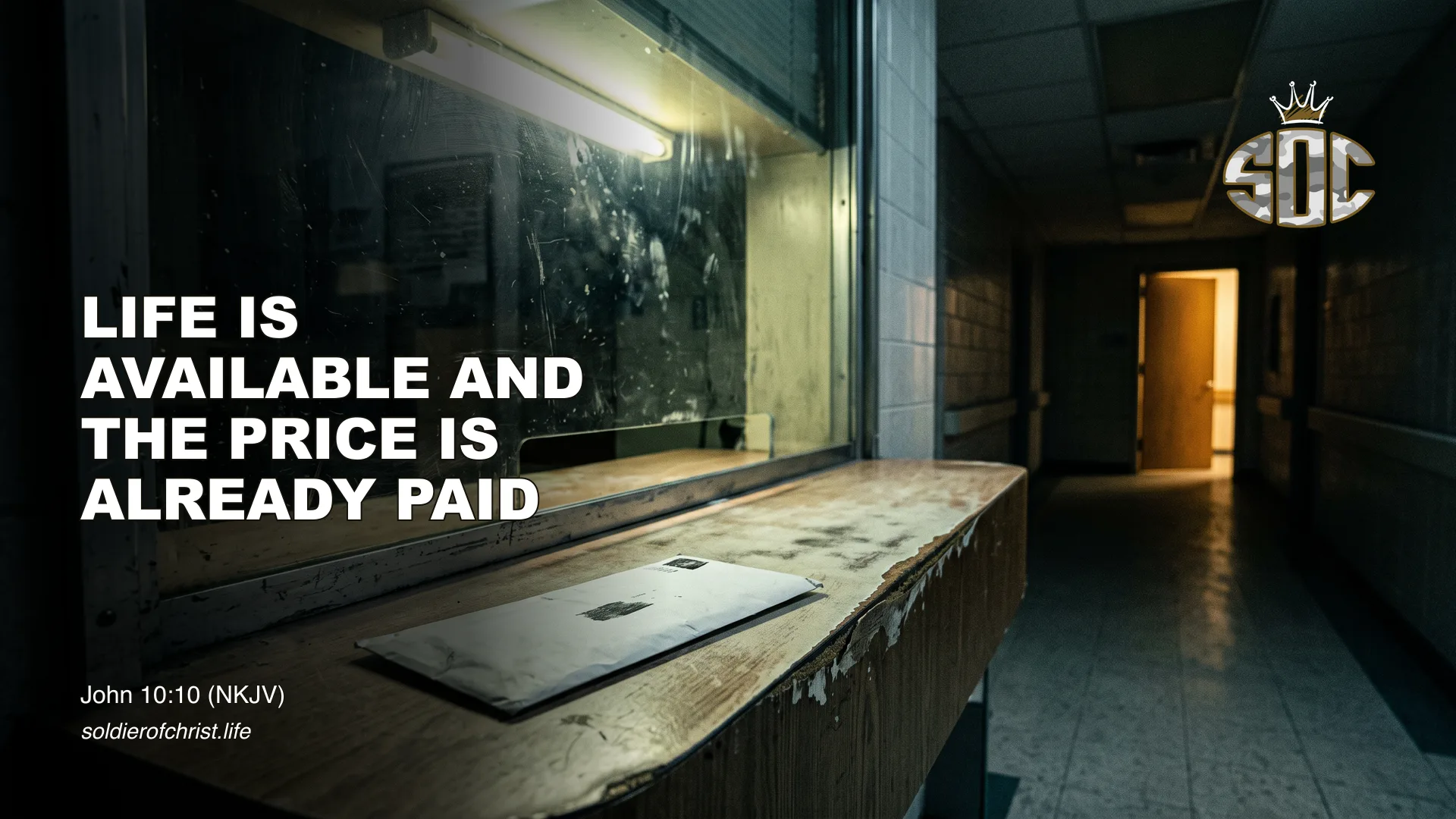 An unopened envelope left on a worn counter at an empty hospital billing window at night, with warm light through an open door down the hall